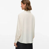 Women’s cream oversized button-up blouse with utility pockets and collared neckline for chic minimalist style.