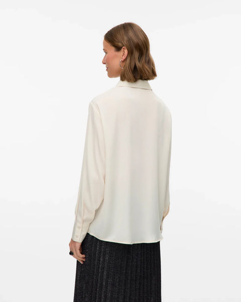 Women’s cream oversized button-up blouse with utility pockets and collared neckline for chic minimalist style.