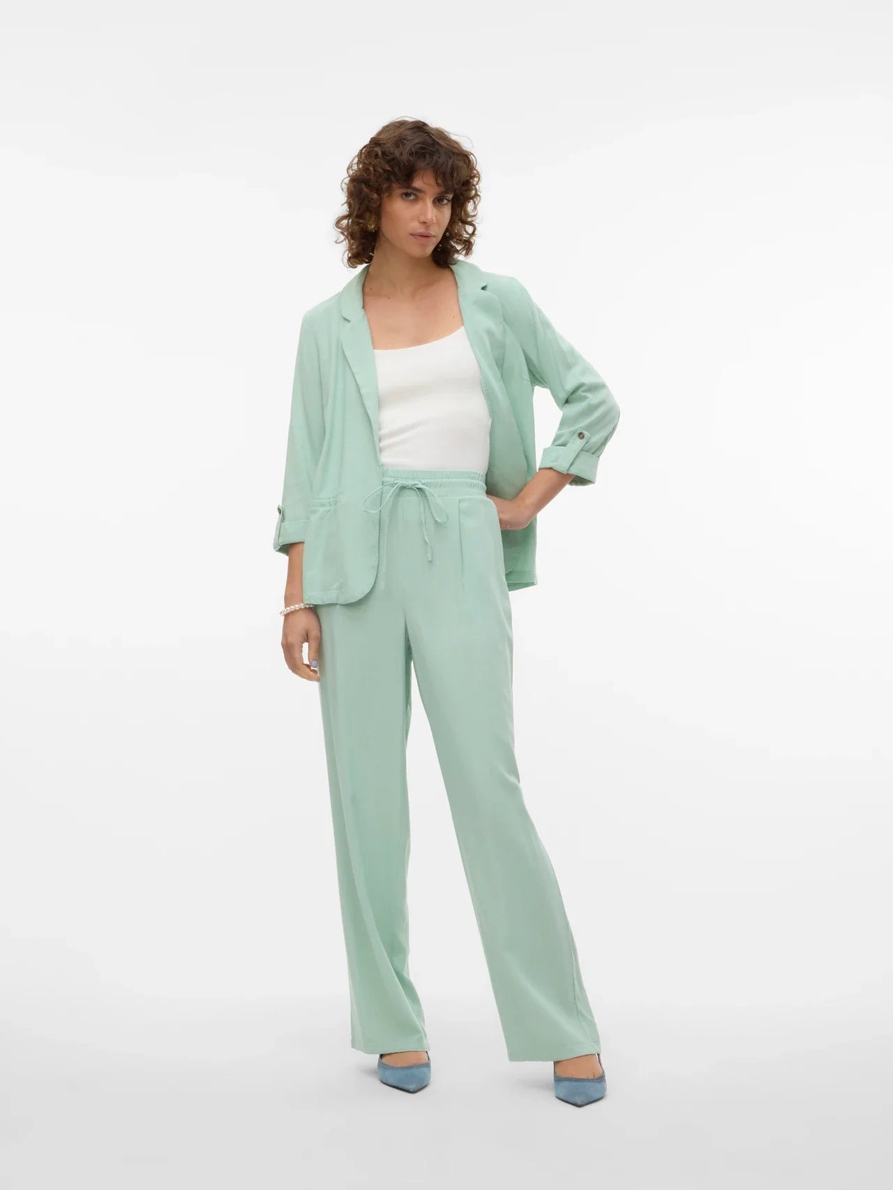 Contemporary mint layering piece with rolled cuffs and chic relaxed silhouette for modern wardrobes.