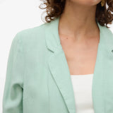 Modern mint green cover-up jacket with fluid drape and elevated resort casual versatility.