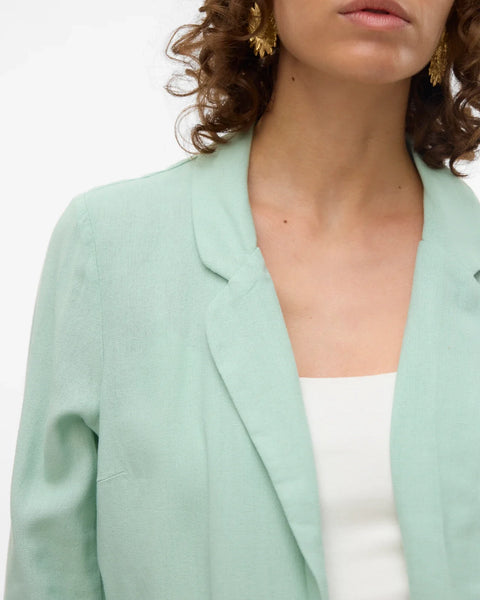 Modern mint green cover-up jacket with fluid drape and elevated resort casual versatility.