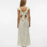 Back full length view of vintage-inspired botanical print dress with romantic frill neckline and graceful flowing fit.