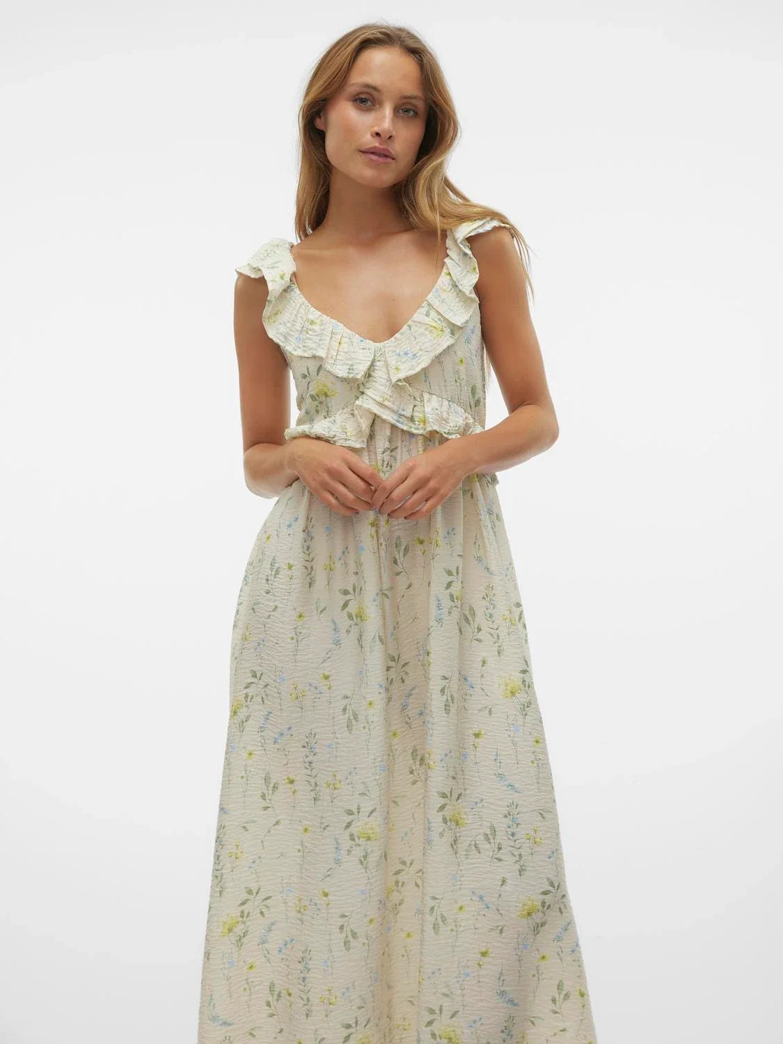 Romantic floral maxi dress with cascading ruffle neckline and soft cottagecore-inspired feminine silhouette.