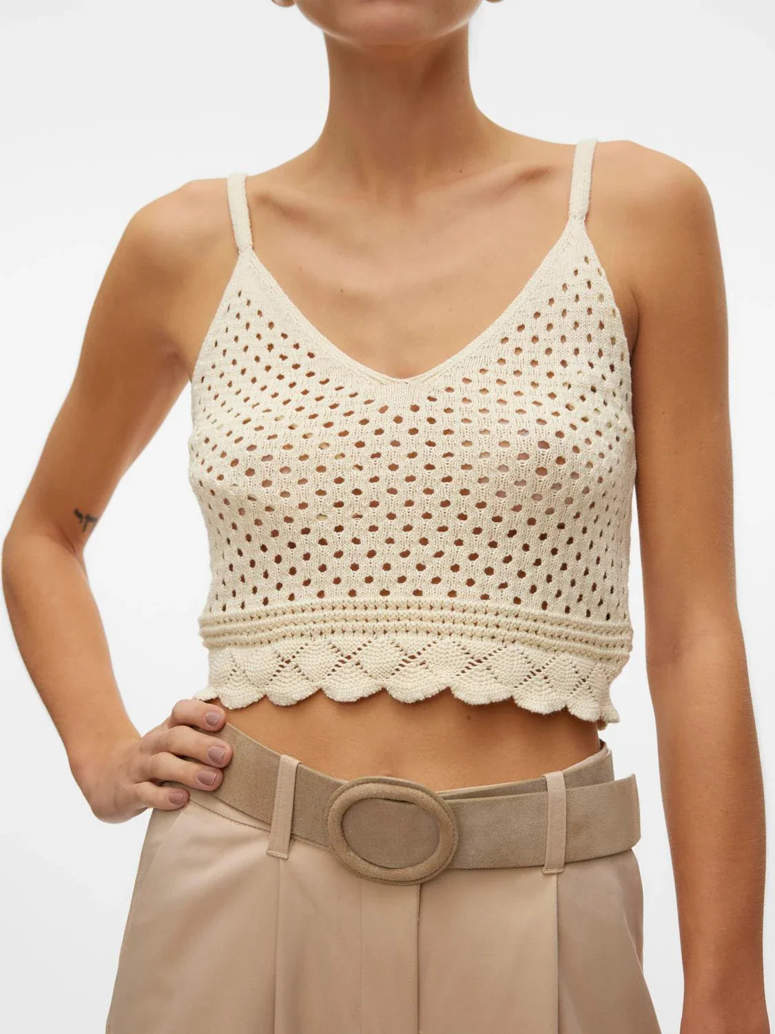 Coastal-inspired knit bralette top featuring breathable crochet design and feminine scalloped hem for effortless layering.