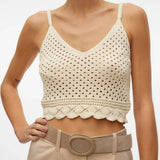Coastal-inspired knit bralette top featuring breathable crochet design and feminine scalloped hem for effortless layering.
