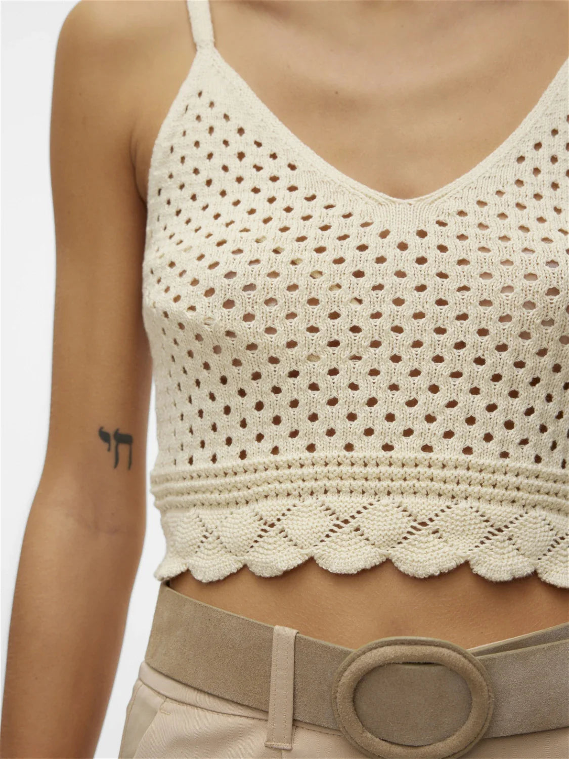 Lightweight ivory crochet bralette with V-neckline and open-knit pattern for chic vacation and festival fashion.