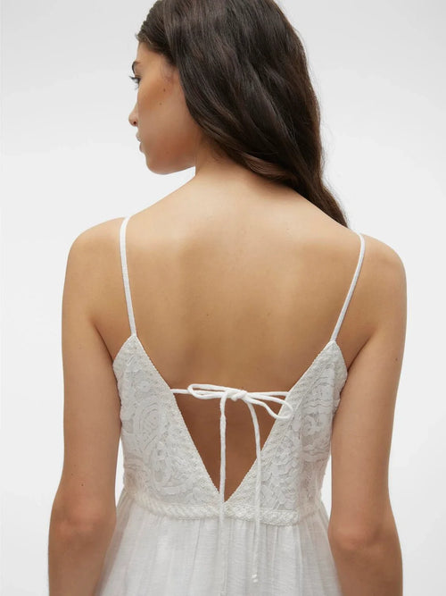 Back tie detail of this white bohemian-inspired maxi dress with lace embroidery and breezy relaxed fit for warm-weather dressing.