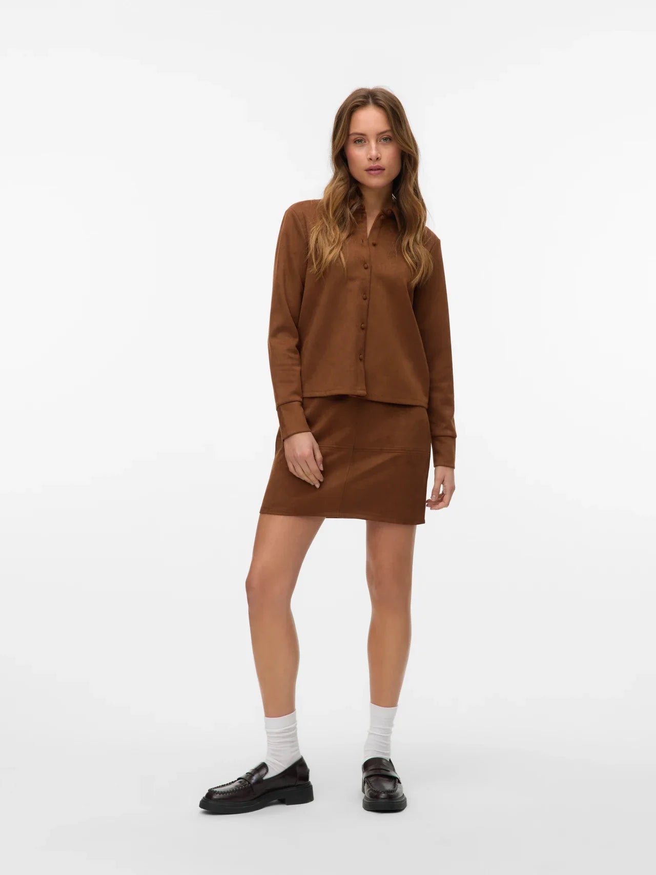 Women’s brown faux suede shirt with tonal buttons and classic collar, a versatile top for fall fashion and layering.