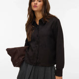 Women's black long-sleeve collared top with button-front design for polished workwear and elevated casual style.