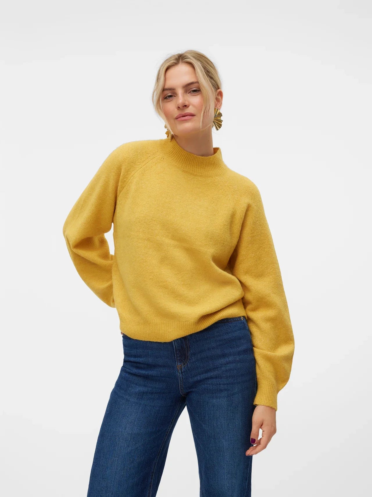 Women’s golden yellow knit sweater with mock neckline and relaxed fit for casual everyday winter outfits.