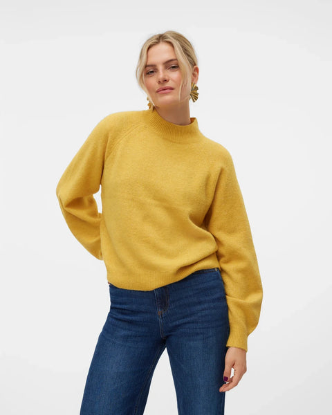 Women’s golden yellow knit sweater with mock neckline and relaxed fit for casual everyday winter outfits.