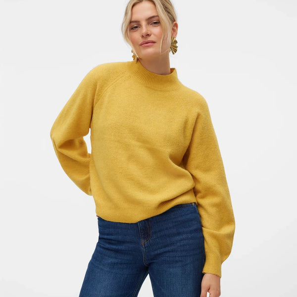 Women’s golden yellow knit sweater with mock neckline and relaxed fit for casual everyday winter outfits.