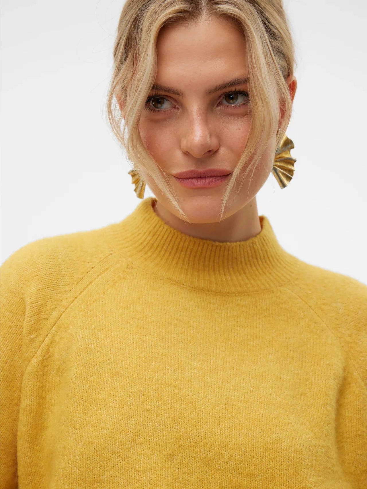 Women’s yellow relaxed-fit sweater with mock neck and soft knit texture for bright fall and winter wardrobe styling.