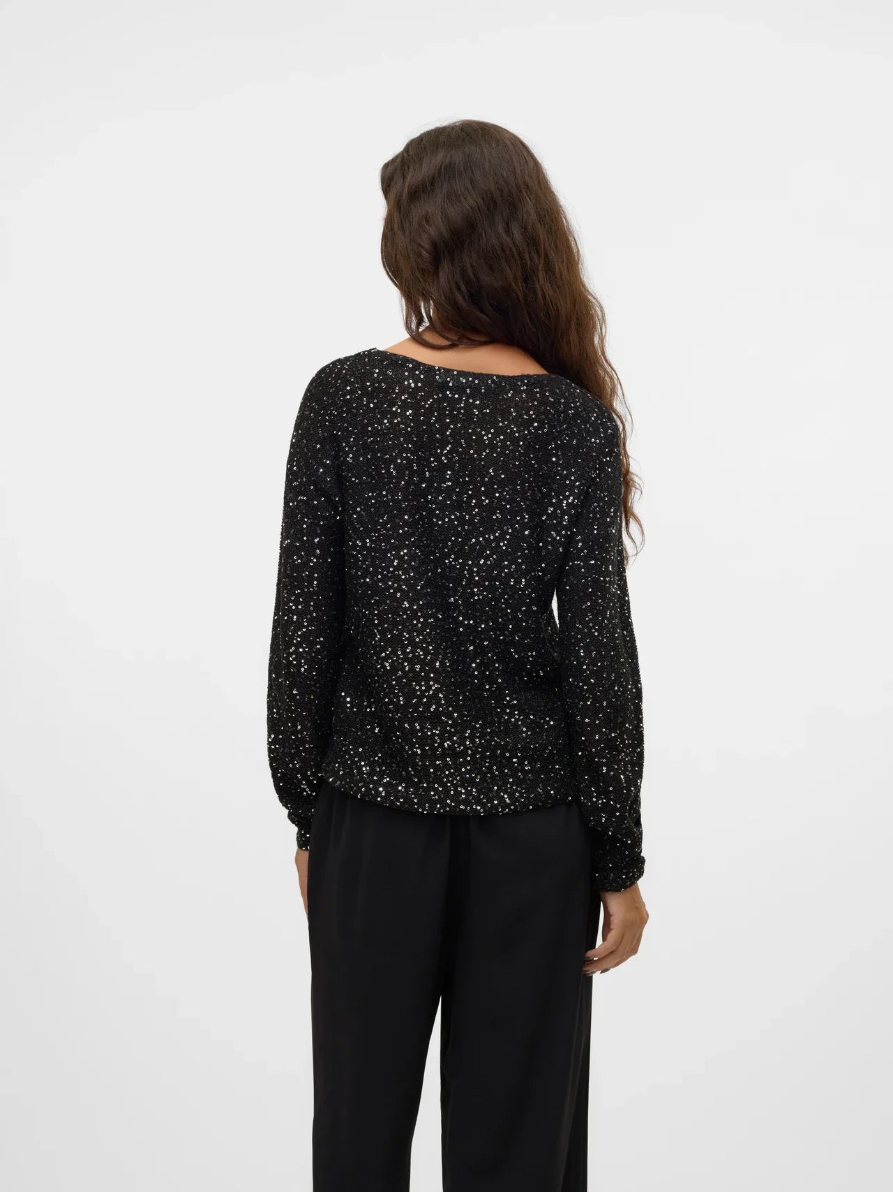 Women's black glitter top with long sleeves and relaxed fit, an elegant going-out top for parties and special occasions.