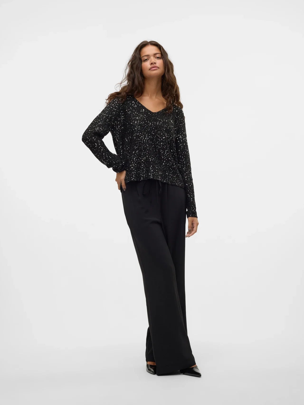 Black long-sleeve party top for women with all-over shimmer, perfect for date night, cocktails and festive occasions.