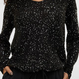 Women's black shimmer long-sleeve top for festive holiday parties and elegant date-night styling.