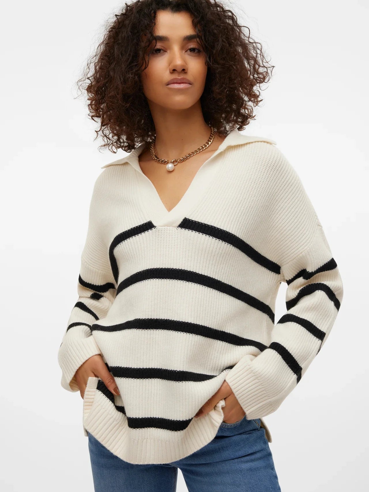 Trendy cream knit sweater with black stripes and cozy relaxed fit for elevated casualwear styling.