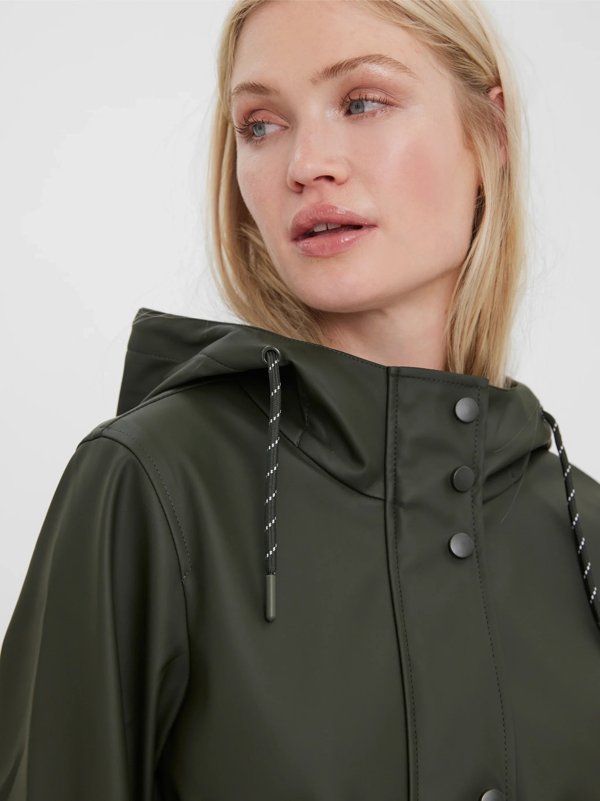 Elevated olive green outerwear with sleek snap-button detail and city-ready sophistication