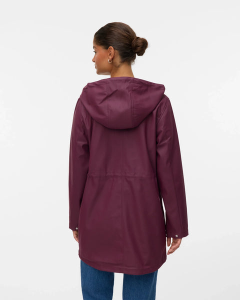 Women’s plum hooded rain jacket with front pockets and adjustable waist for commuting and travel.