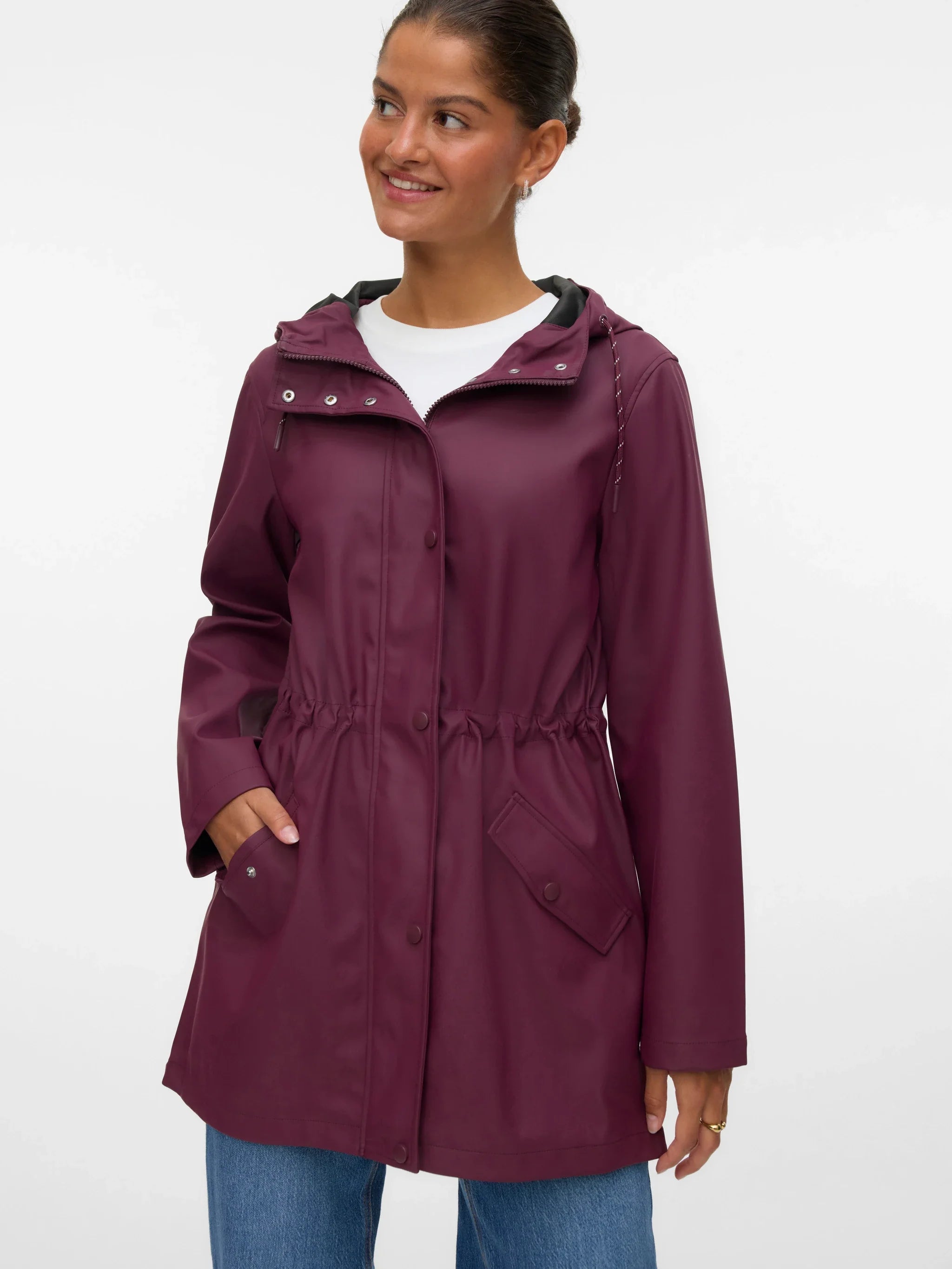 Women’s burgundy hooded raincoat with adjustable drawstring waist, front pockets, and snap closure for stylish rainy-day outfits.