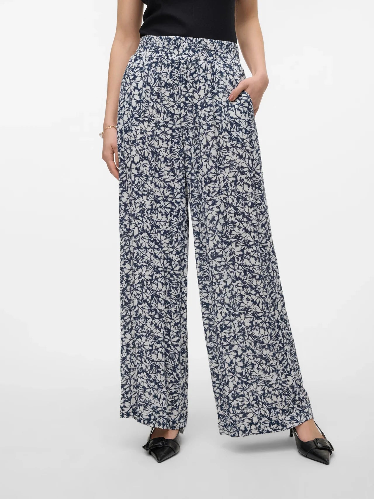 Stylish monochrome floral pants with fluid movement and contemporary fashion-forward silhouette.