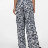 Back view of Chic black and white floral trousers with relaxed fit and polished minimalist fashion appeal.
