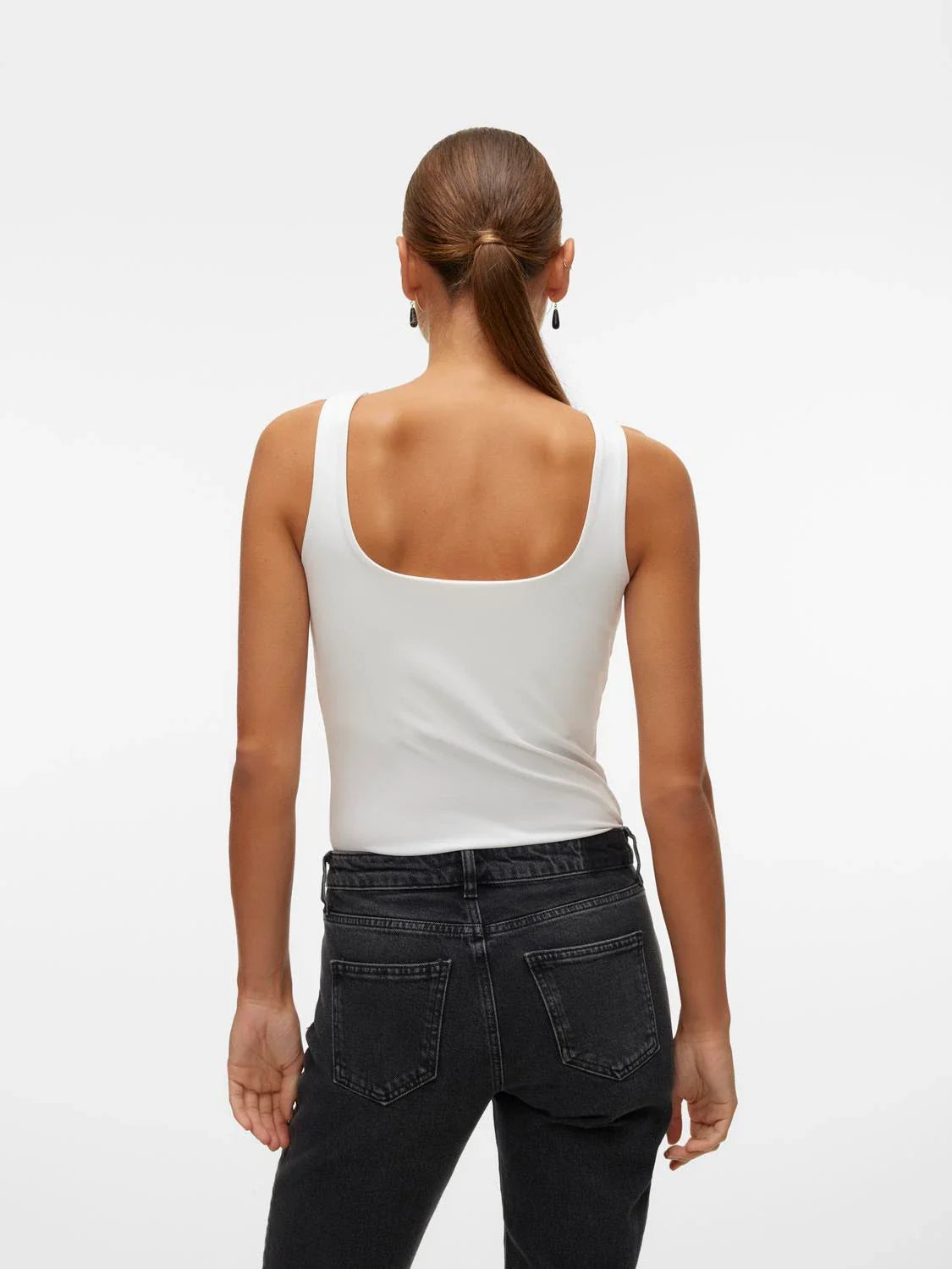 Back view of modern women’s white sleeveless essential top with tailored fit and sophisticated minimalist styling.