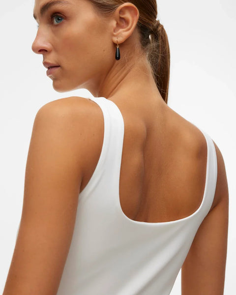 Modern sleeveless white top with contemporary crew neckline and streamlined fit for effortless casual styling.