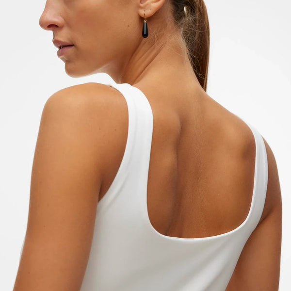 Modern sleeveless white top with contemporary crew neckline and streamlined fit for effortless casual styling.