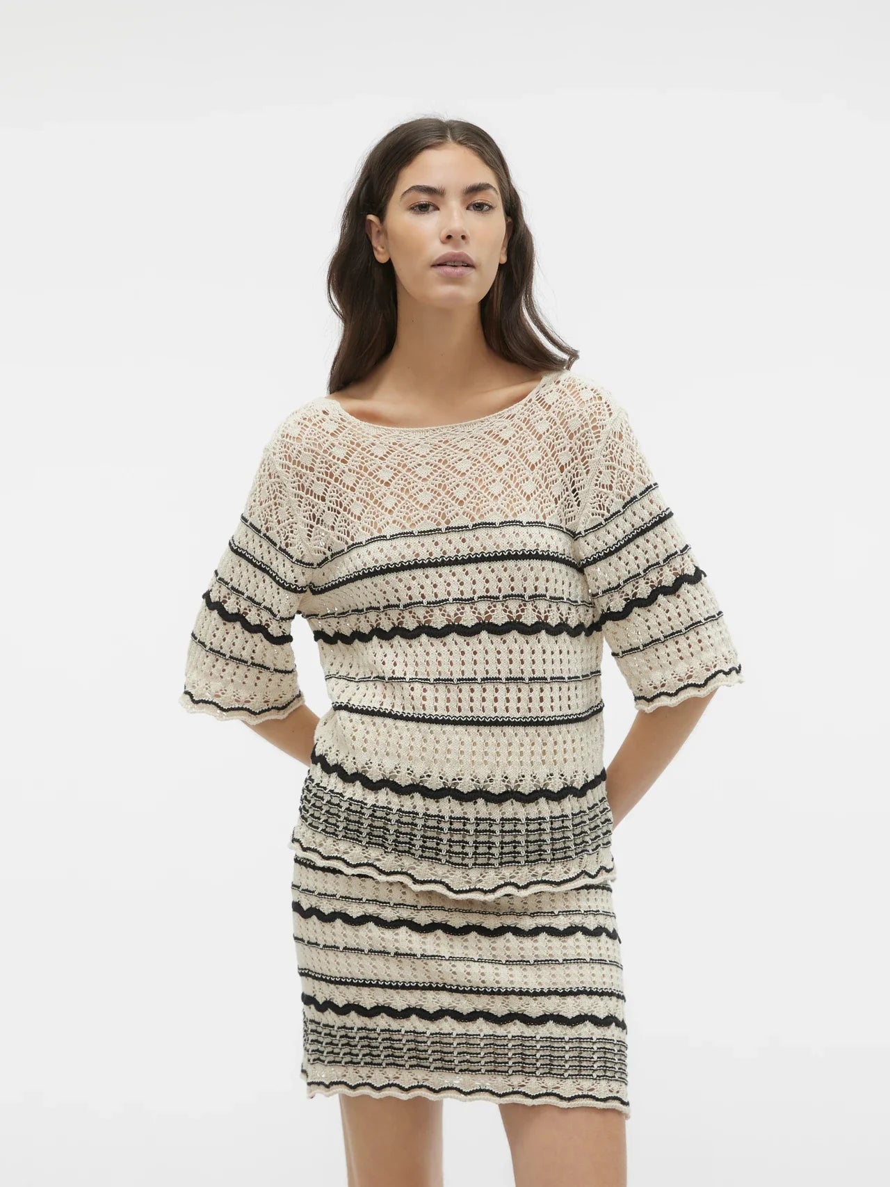 Stylish boho knit top with open crochet detailing and contrast stripes for effortless transitional season outfits.