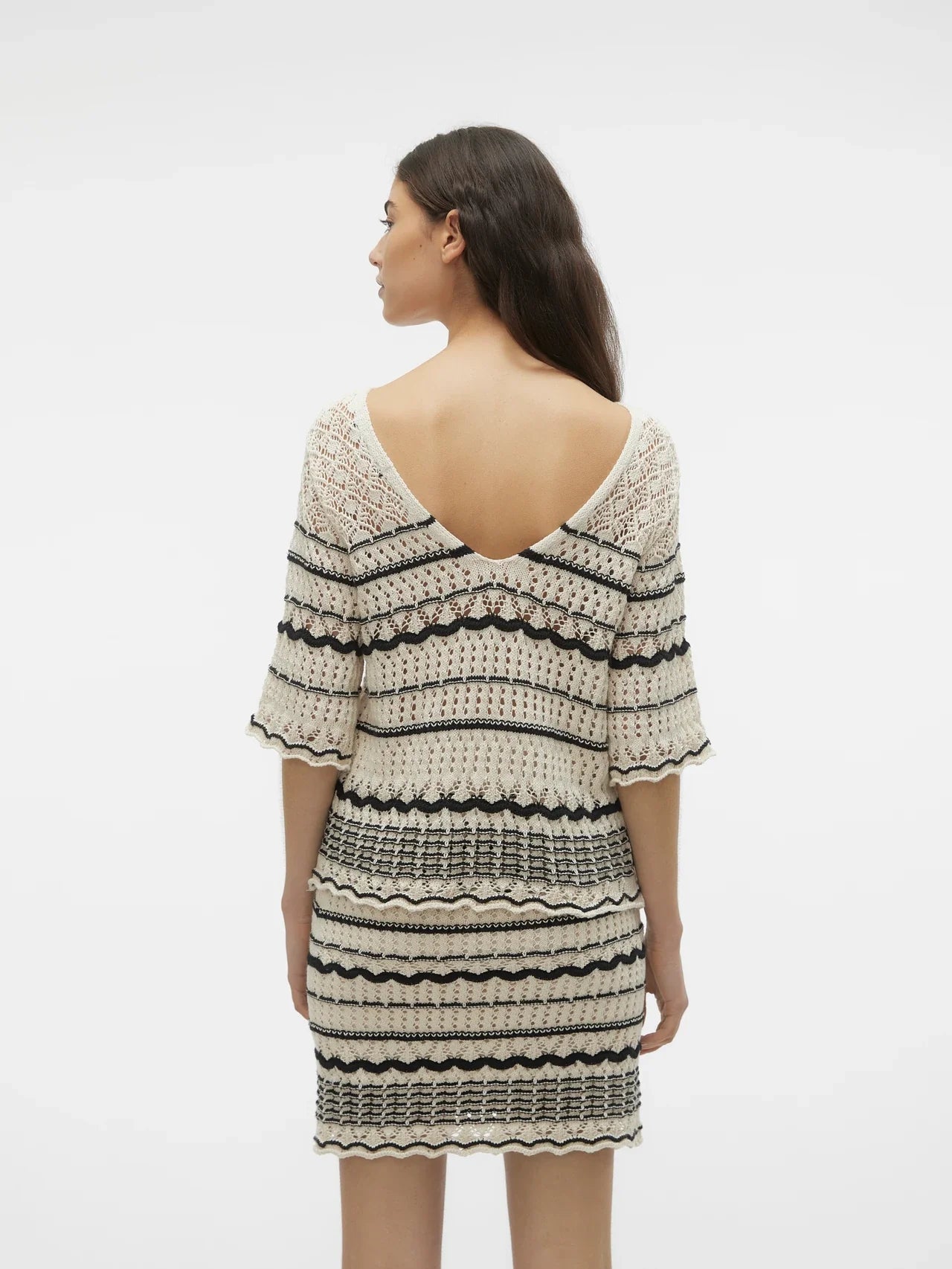 Chic open stitch sweater top with contrast black stripe pattern and relaxed fit for modern boutique wardrobes.