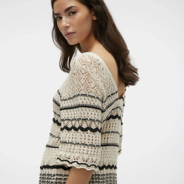 Cream and black open knit top with feminine scalloped stripe accents and contemporary bohemian-inspired silhouette.