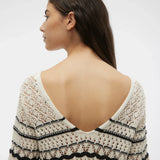 Neck detail of this women’s cream crochet blouse with black contrast detailing and soft bohemian luxury-inspired casual fashion look.