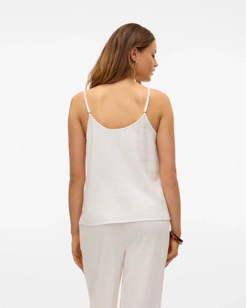 Modern white camisole blouse with adjustable spaghetti straps and breezy relaxed silhouette for warm-weather fashion.