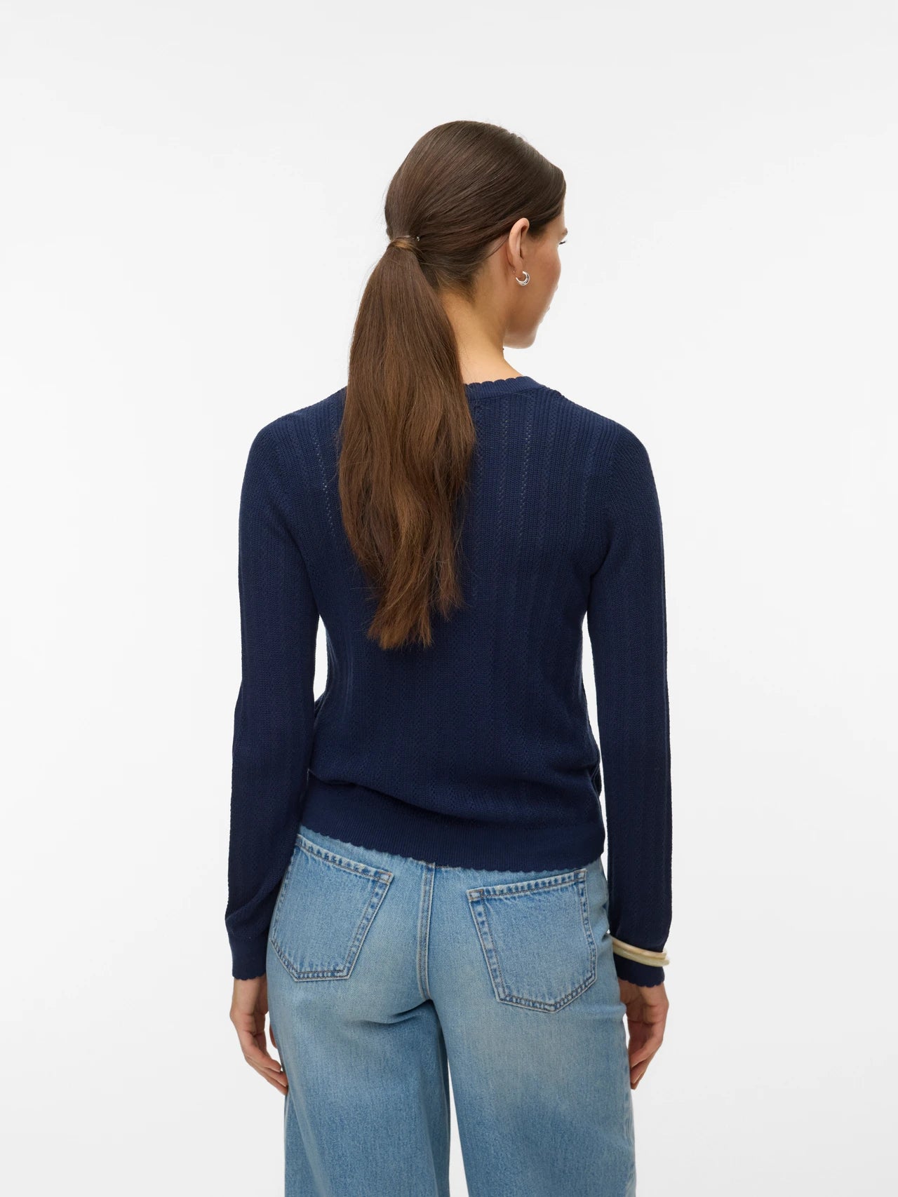 Women's classic navy button-up cardigan with fine knit texture and fitted silhouette for versatile office and weekend styling.