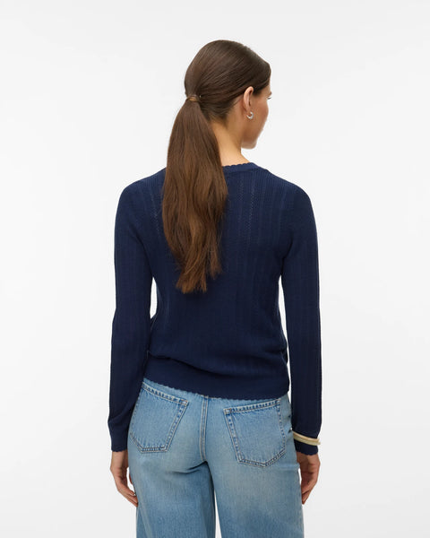 Women's classic navy button-up cardigan with fine knit texture and fitted silhouette for versatile office and weekend styling.
