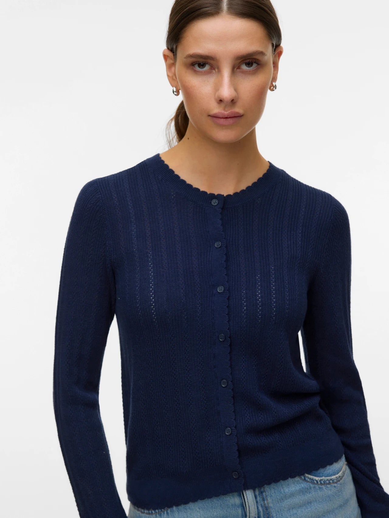 Navy blue lightweight knit cardigan with long sleeves, button front and feminine scalloped detailing for work and everyday outfits.