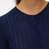 Elegant women's navy blue crew neck cardigan featuring delicate knit texture, tonal buttons and scalloped trim for polished layering.