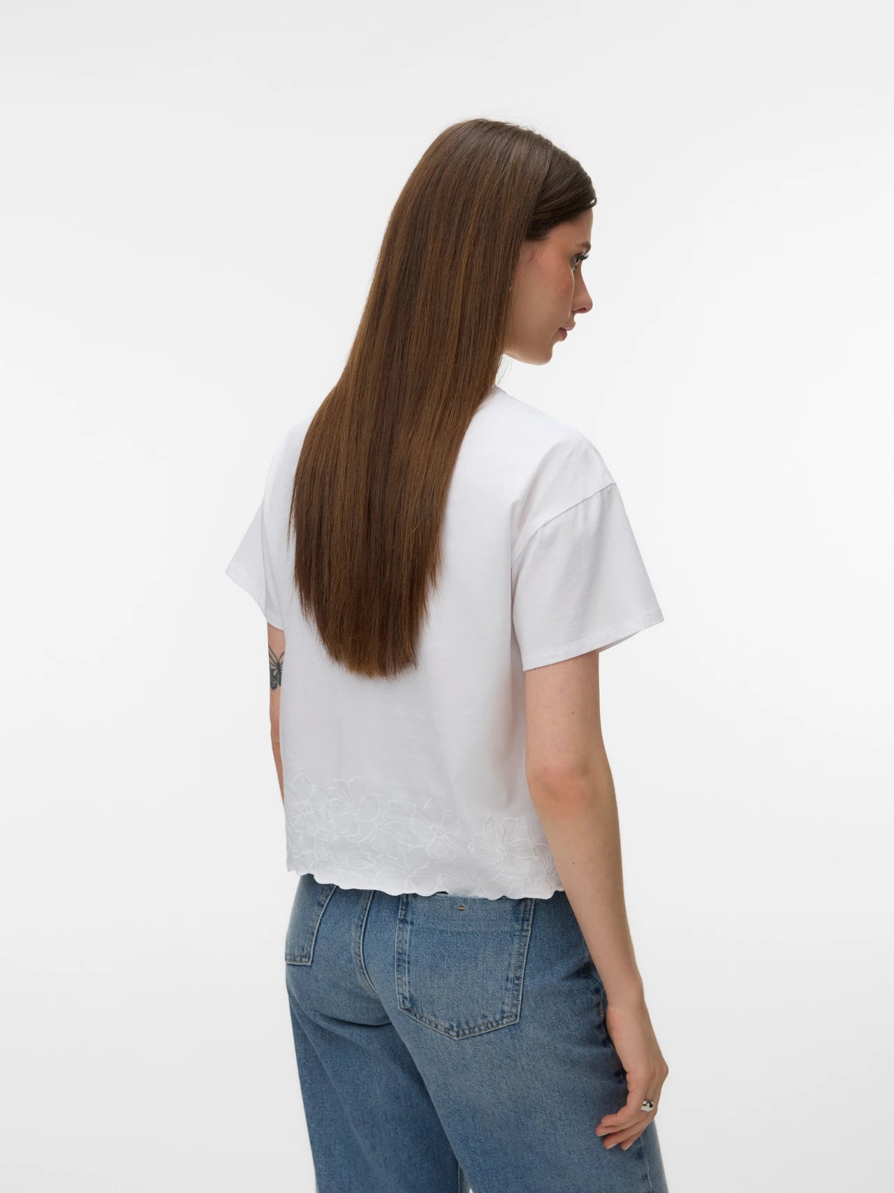 Elegant women's white short sleeve blouse with floral embroidery, crew neckline and refined everyday style for capsule wardrobes and resort wear.