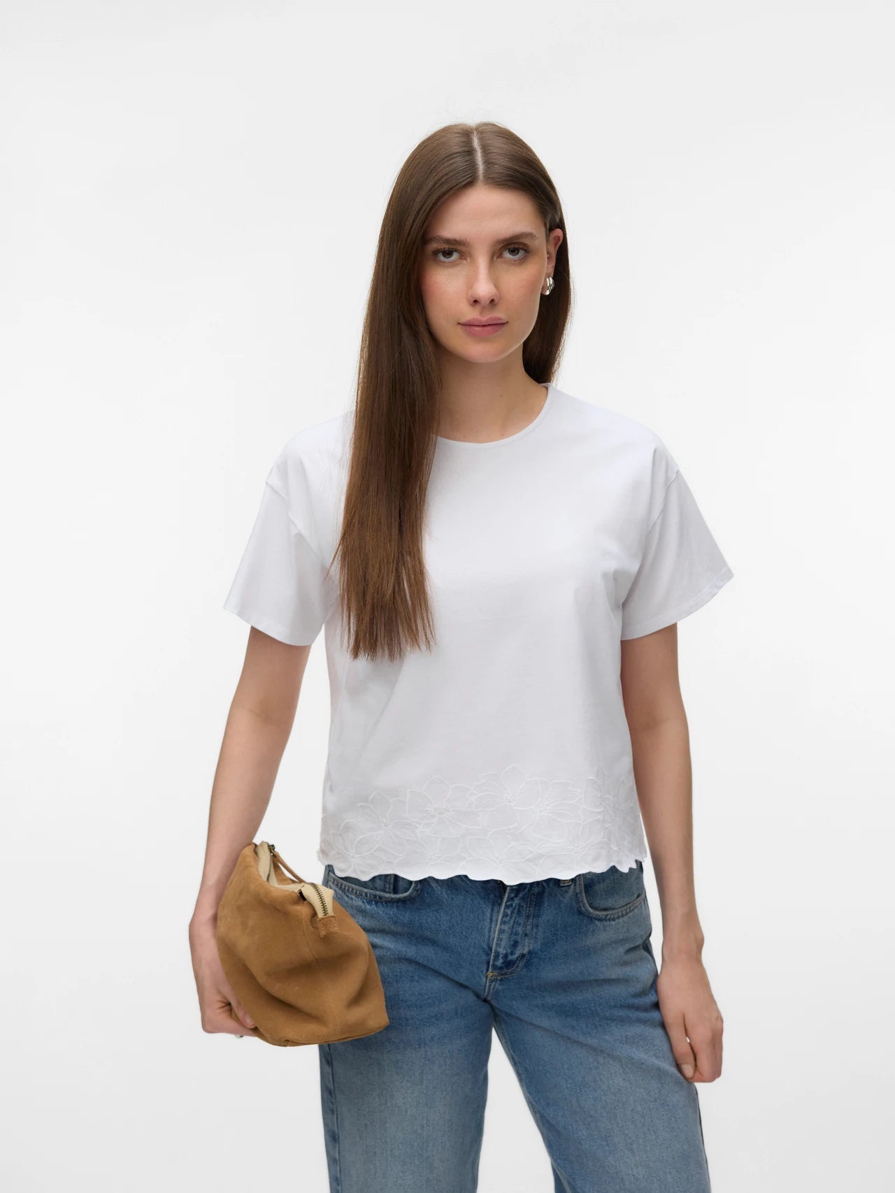Elegant white woven top with subtle floral embroidery, relaxed fit and classic crew neckline for office, travel and weekend outfits.