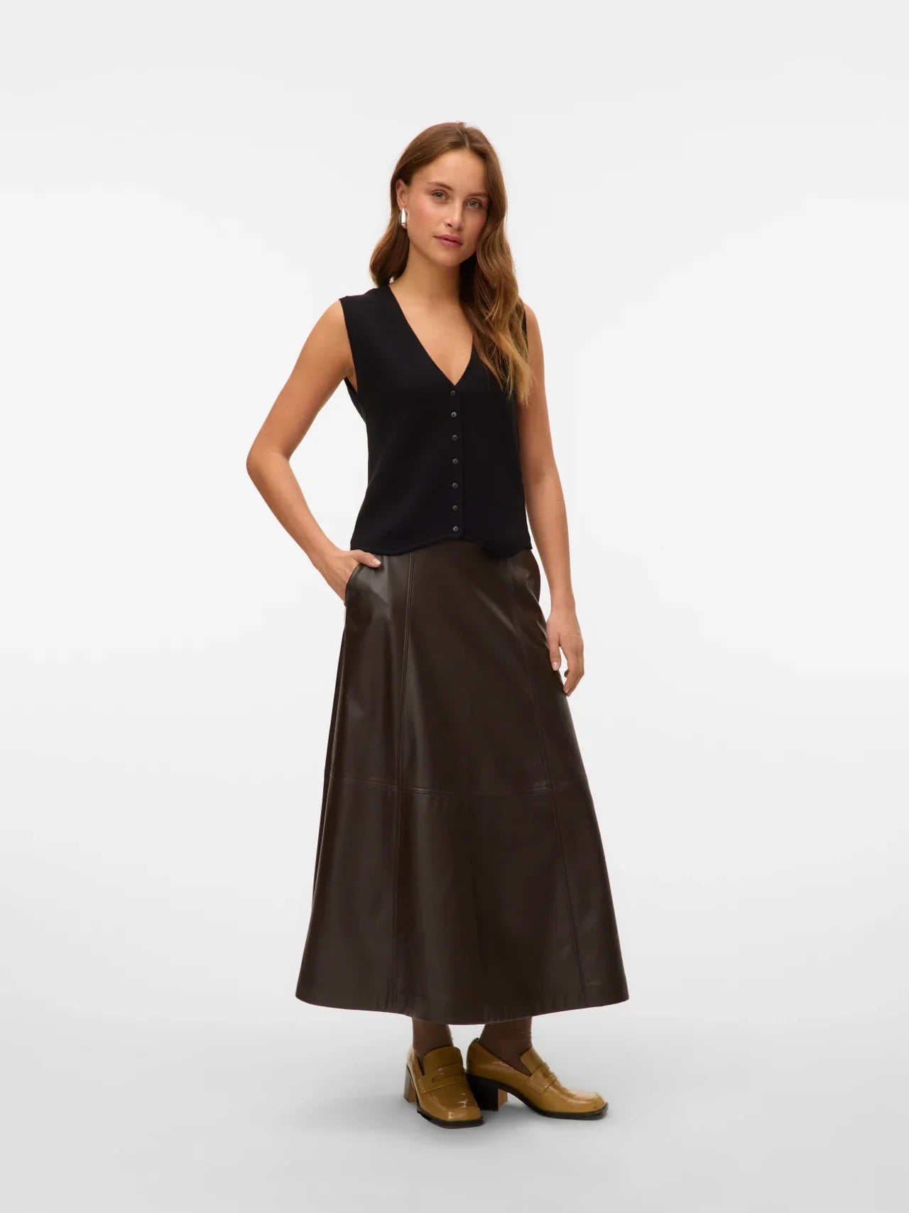 Women’s chocolate brown vegan leather midi skirt with flattering A-line silhouette and panel seams.