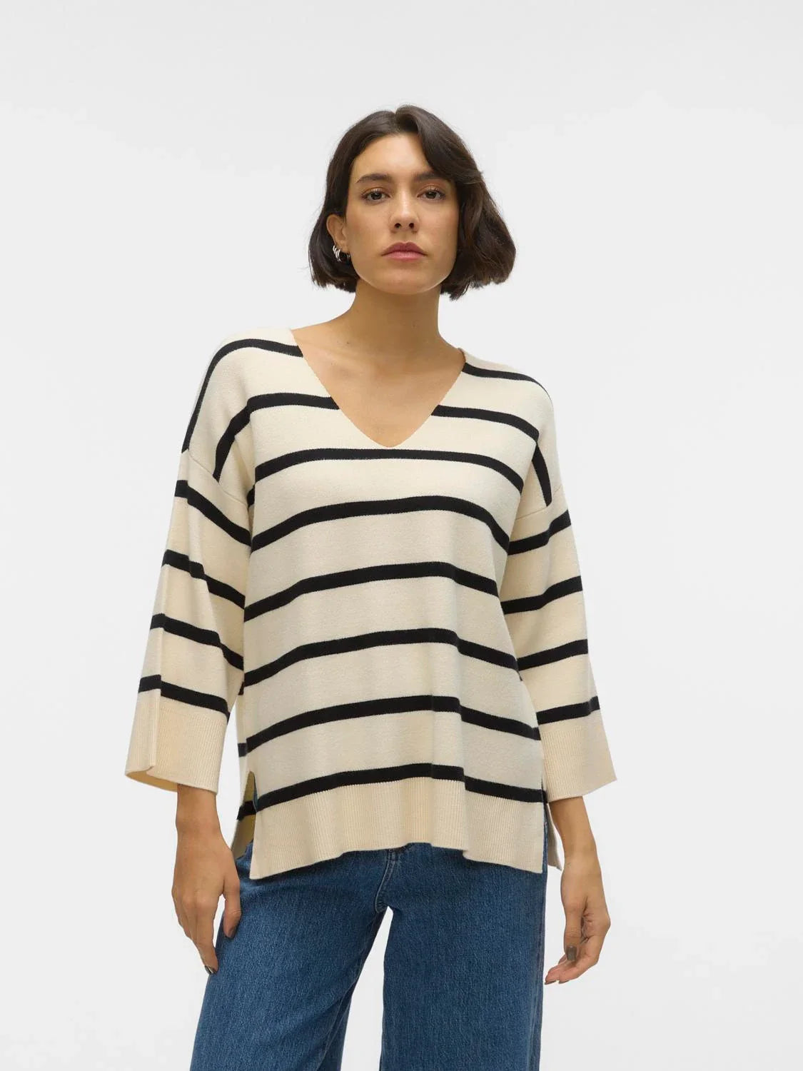 Soft knit striped sweater featuring neutral cream tones and loose fit for elevated casual and weekend outfit styling.