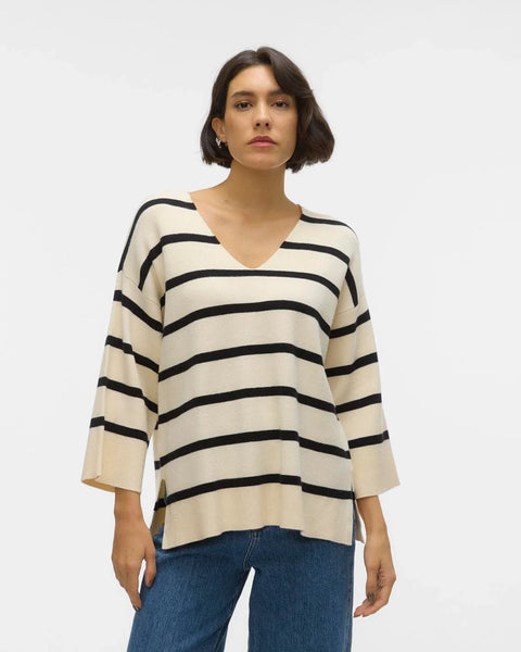 Soft knit striped sweater featuring neutral cream tones and loose fit for elevated casual and weekend outfit styling.