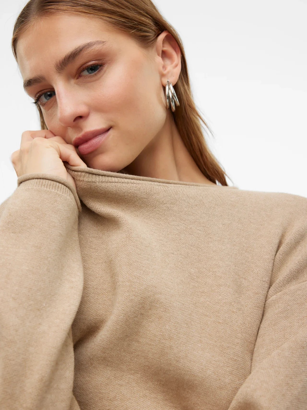 Chic relaxed-fit beige sweater for women featuring a clean neckline and soft lightweight knit texture.