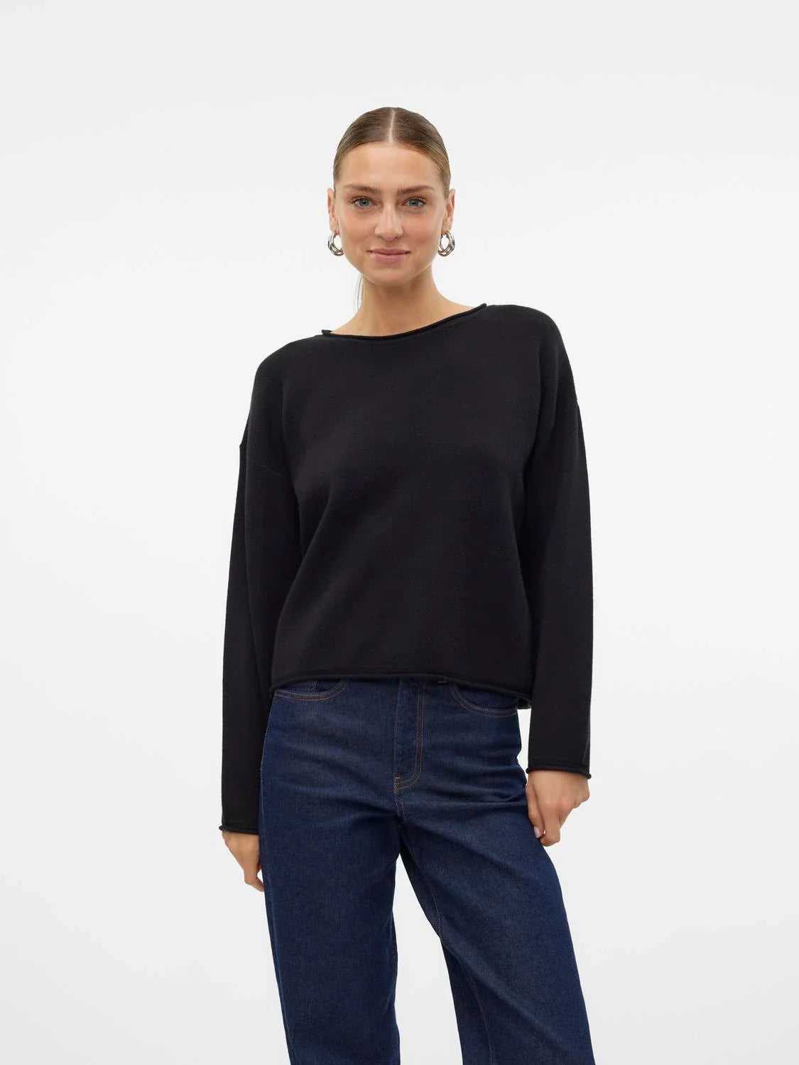 Women’s black lightweight sweater paired with vintage-inspired denim jeans for elevated casual wear.