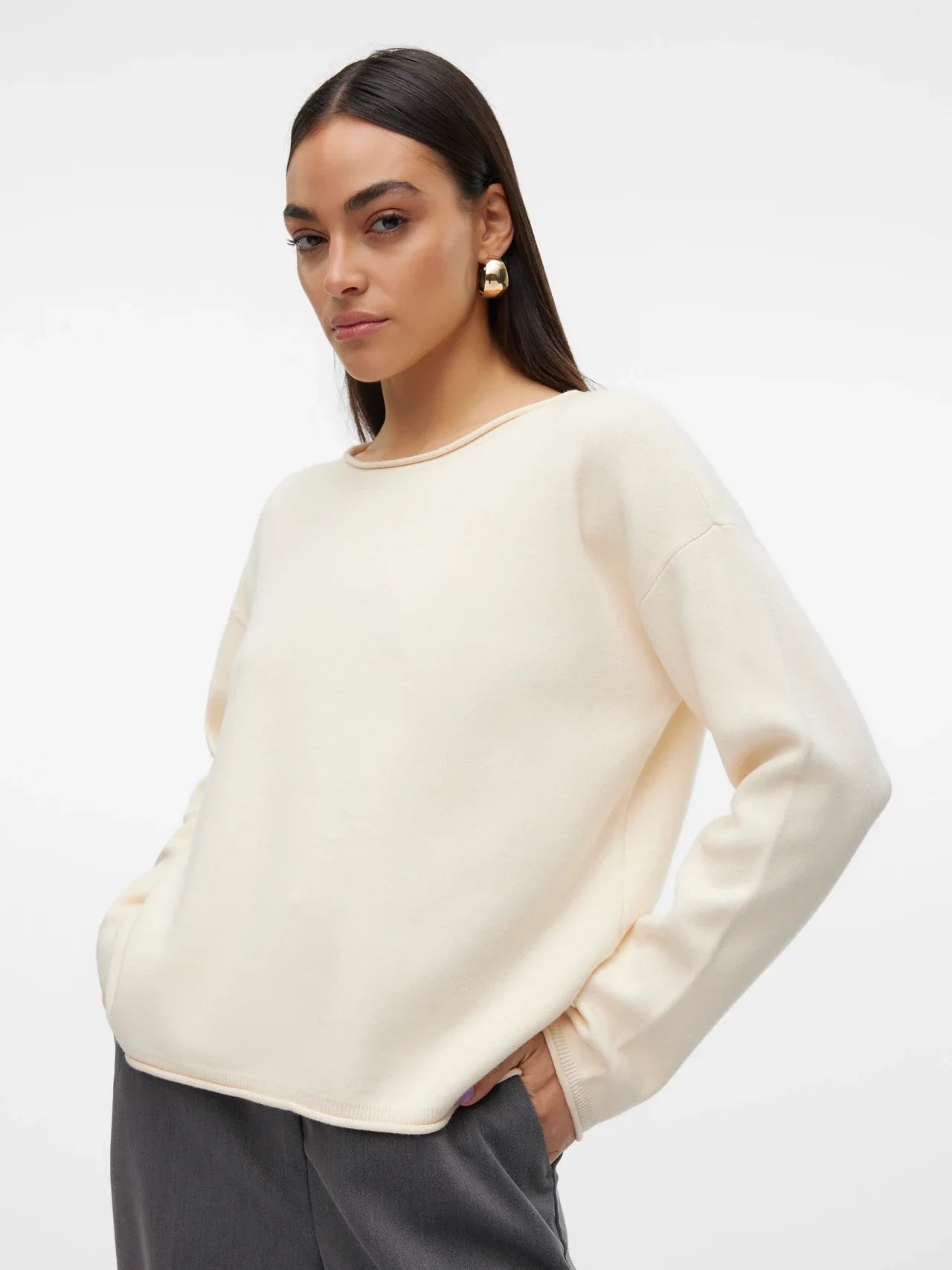 Minimalist creme-colored long sleeve knit sweater with soft texture and elevated casual boutique fashion aesthetic.