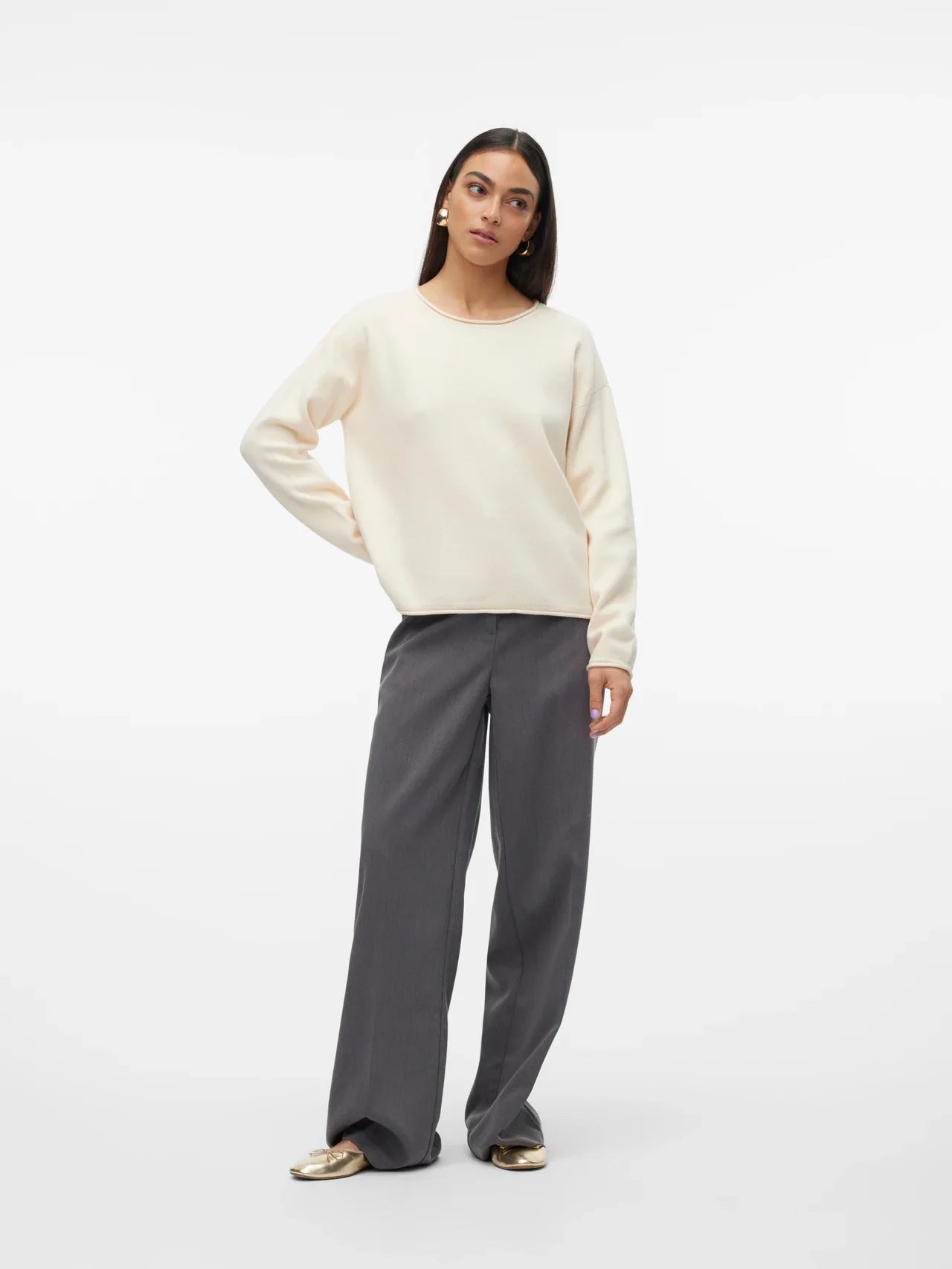 Chic off-white crewneck knit top paired with light wash jeans for modern casual street-style fashion.