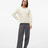 Chic off-white crewneck knit top paired with light wash jeans for modern casual street-style fashion.