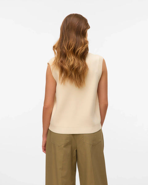 Women’s cream button-up knit vest with sleeveless silhouette for chic outfits with trousers, denim, and skirts.