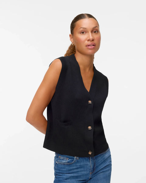 Women’s black sweater vest with button front, V-neckline, and patch pockets for chic layered and minimalist outfits.